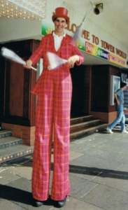 Adrian Catch stiltwalking on Blackpool Promenade outside Blackpool Tower then called 'Tower World'.