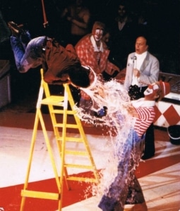 Adrian Catch stooging for the Rastelli Clowns in 1982 tipping the bucket of water onto Oreste Rastelli. Ringmaster Norman Barrett looks on.